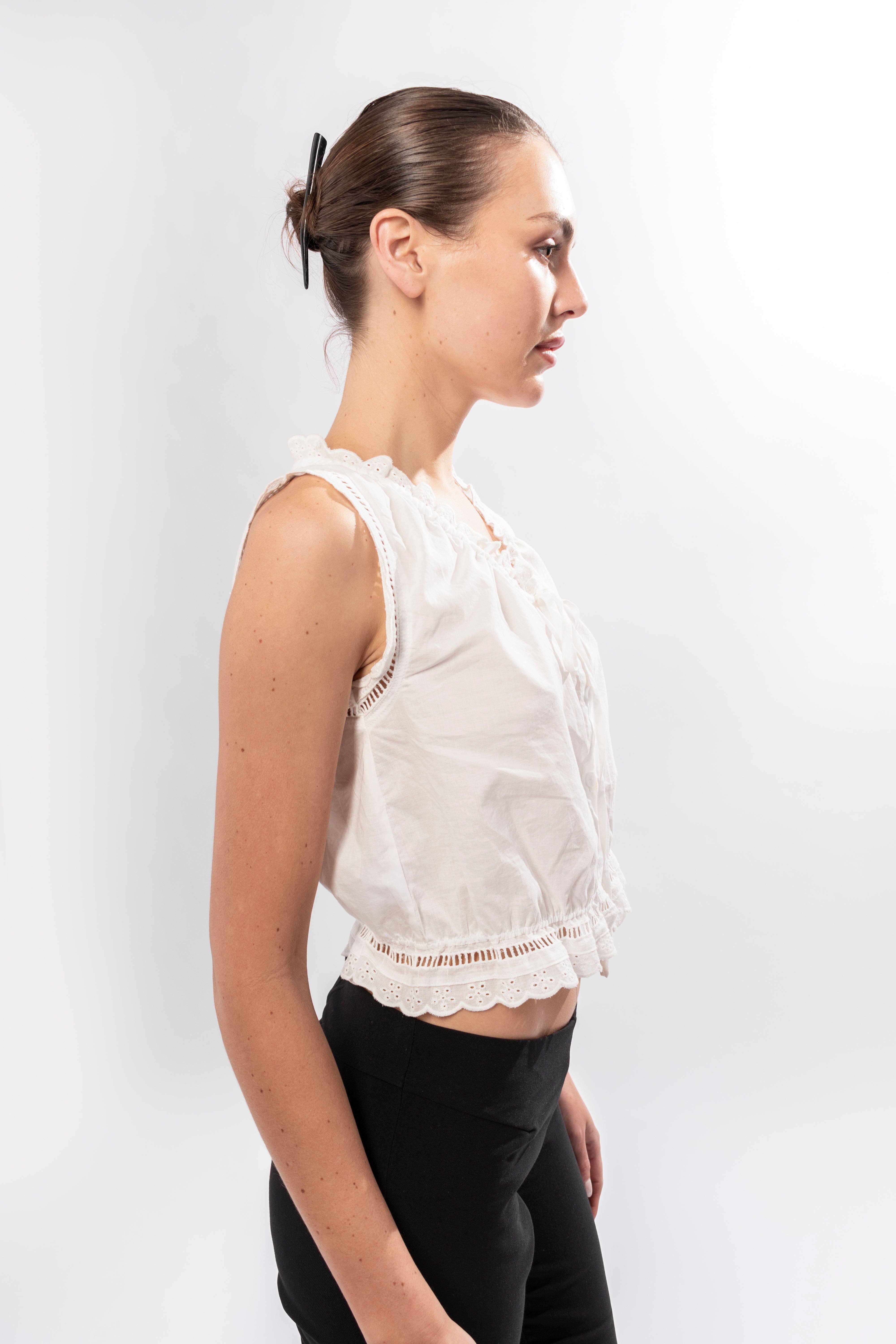 White sleeveless cotton top with broderie detailing and adjustable front ties
