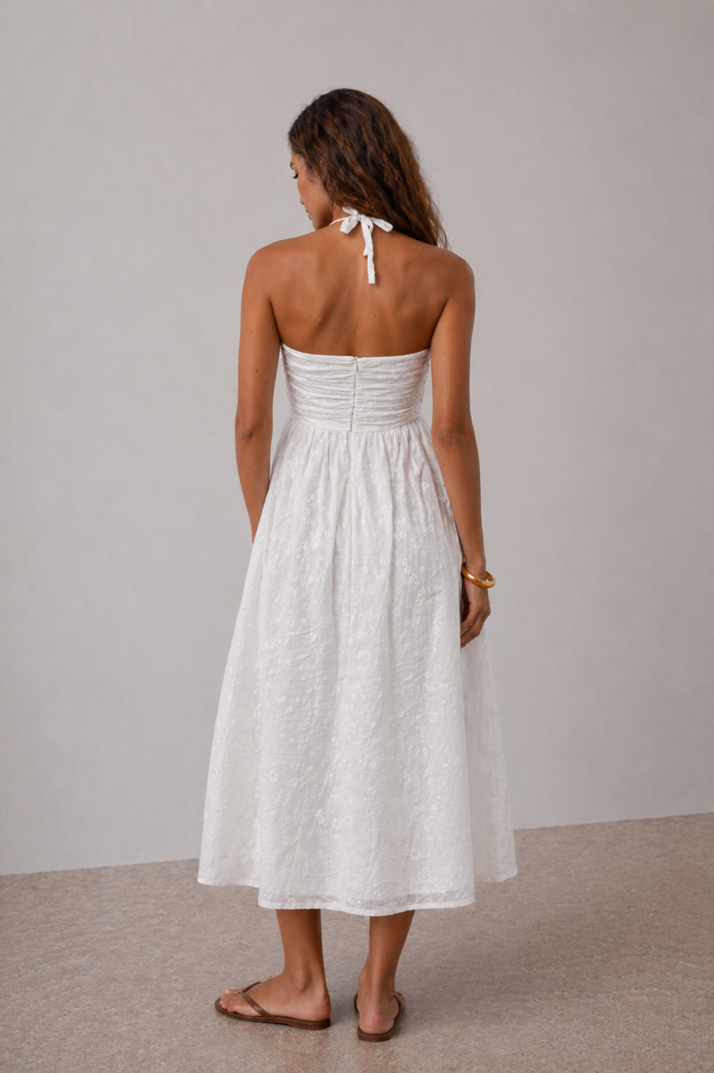 Model wearing white embroidered maxi dress styled for summer