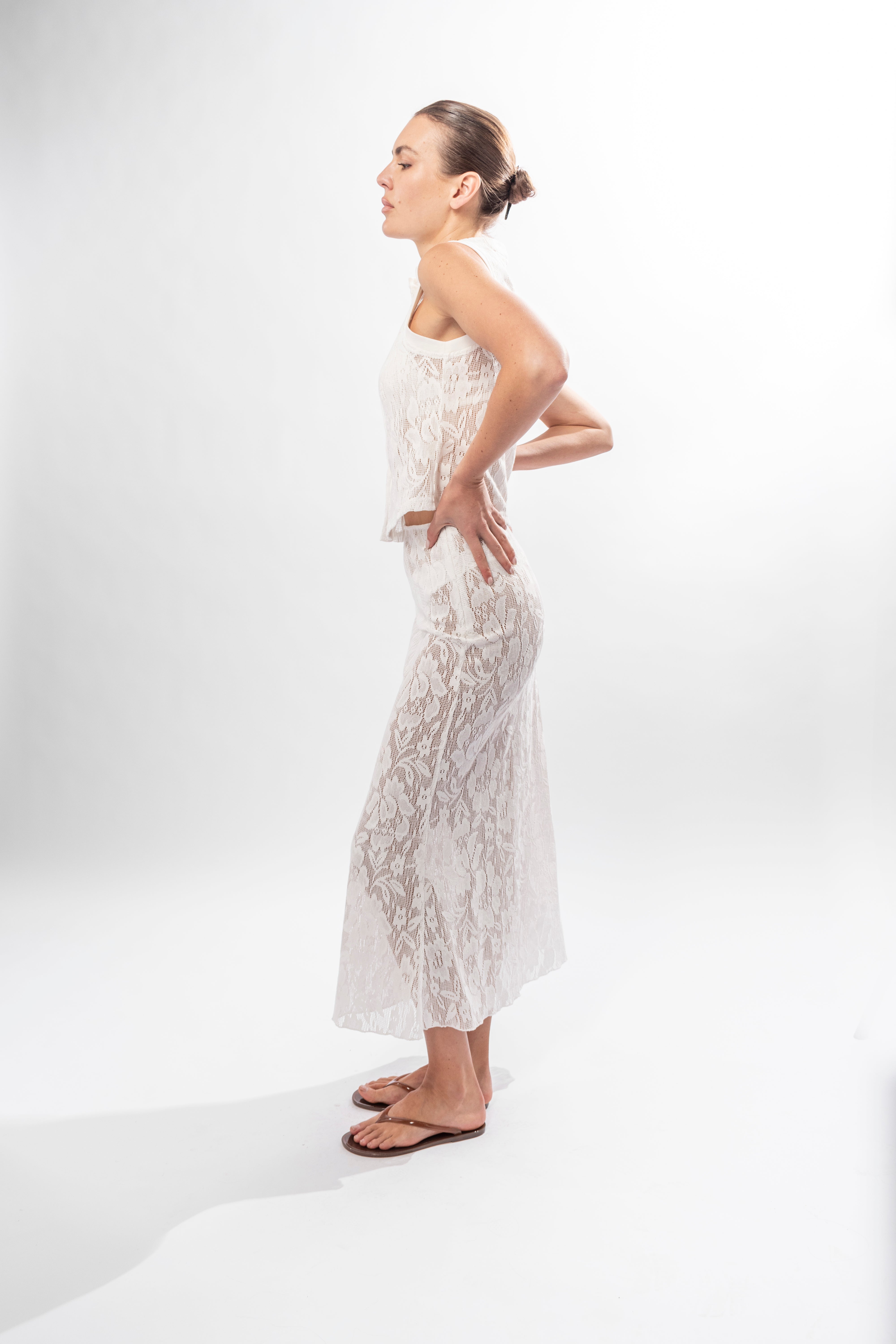 Side view of white lace skirt showing fluid movement and midi length