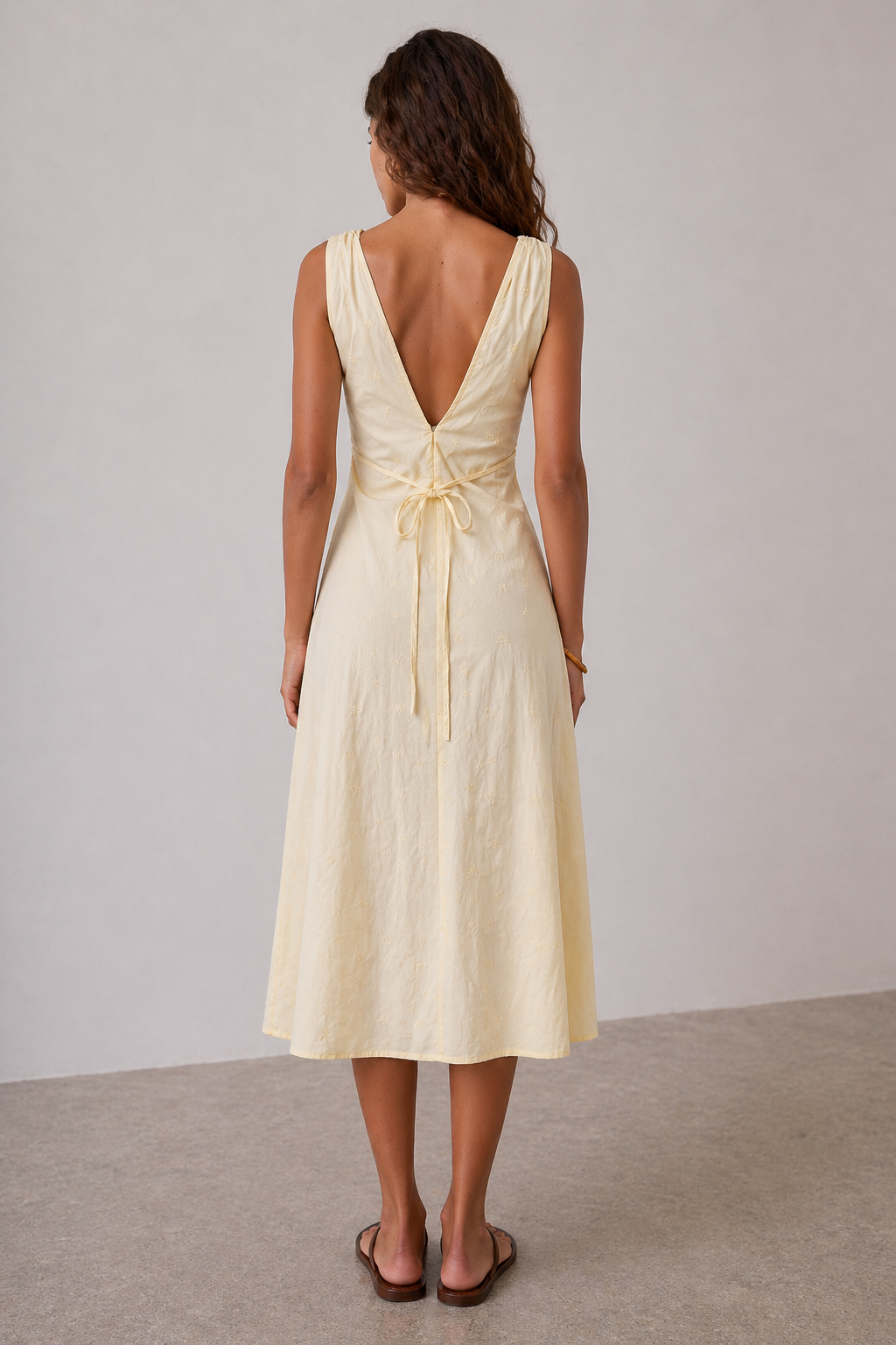 Close-up of ditsy floral embroidery on butter yellow dress